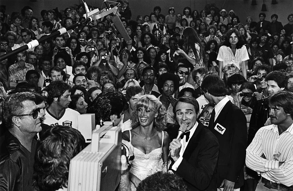 Olivia Newton-John is interviewed by red carpet emcee Army Archerd at the 1978 Hollywood, California film premiere of “Grease”.