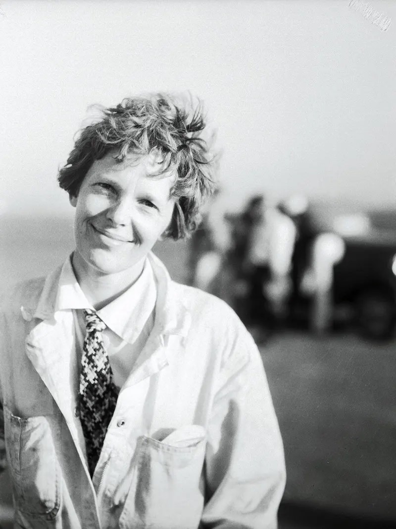 #25 “Amelia Earhart, first lady of aviation, is shown immediately after she landed her Lockheed Vega plane at the Los Angeles Municipal Airport, July 2, after completing a transcontinental flight from the East.
