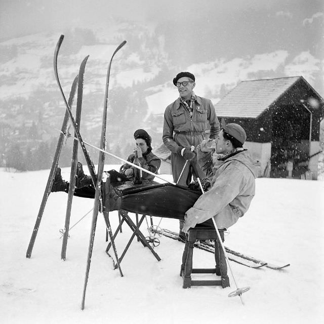 #12 People have a drink while skiing near the cable car line departure station in Saint-Gervais-les-Bains, France, February 1949.