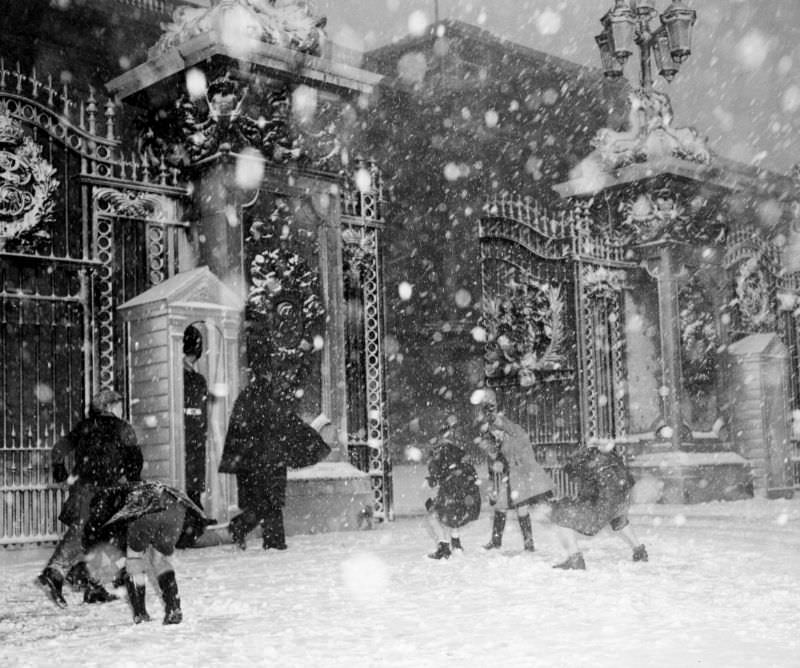 #14 Children throw snowballs in front of Buckingham Palace, London, January 1955.