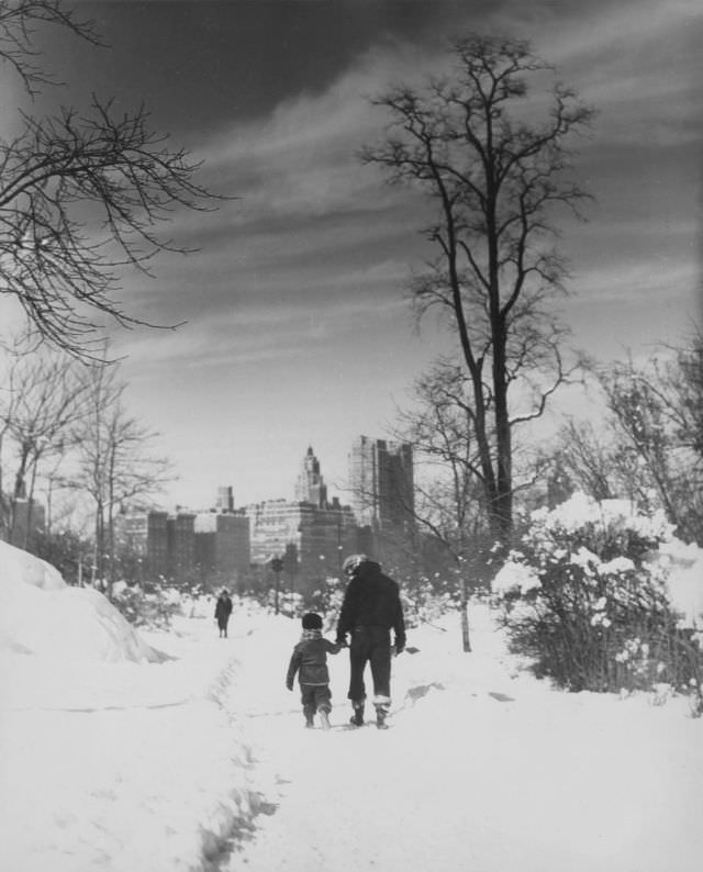 #36 People walking on a snow-covered path, 1929.
