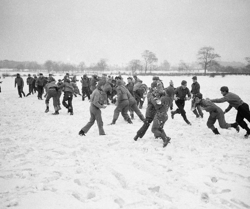 #6 Army troops enjoy a snowball fight at a base in Northern Ireland, April 1942.