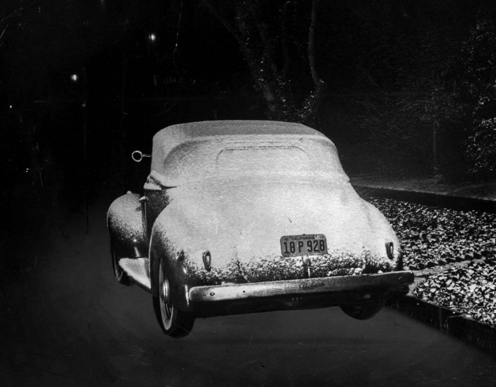 #3 An automobile parked near the Rose Bowl at Linda Vista Avenue and Lida Street sits covered with snow.
