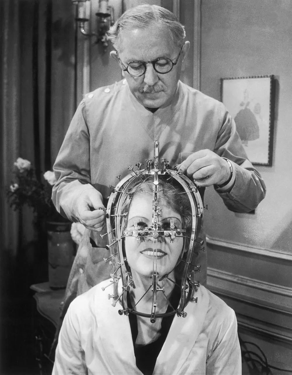 #5 Max Factor takes measurements of actress Marjorie Reynolds’ facial features using a beauty micrometer