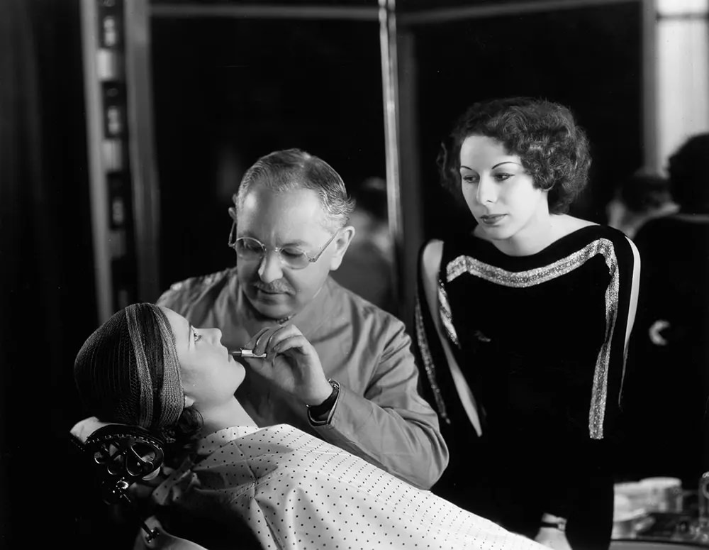 #8 Factor demonstrates a technique for applying lipstick. 1930.