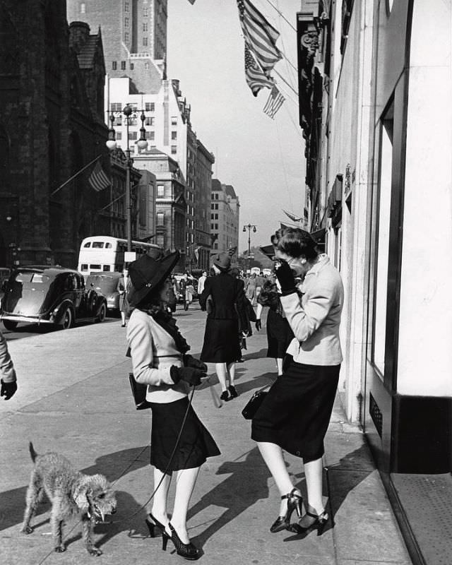 #9 Two women talking on the sidewalk of Fifth Avenue in midtown, New York, 1942.