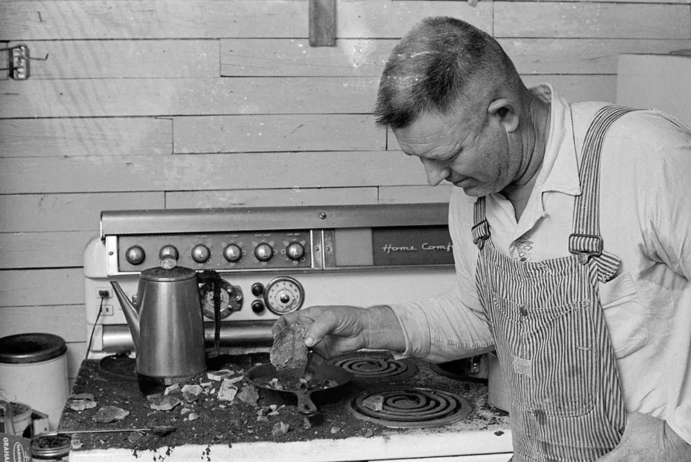 #19 Horace Burge surveys the damage to his kitchen.