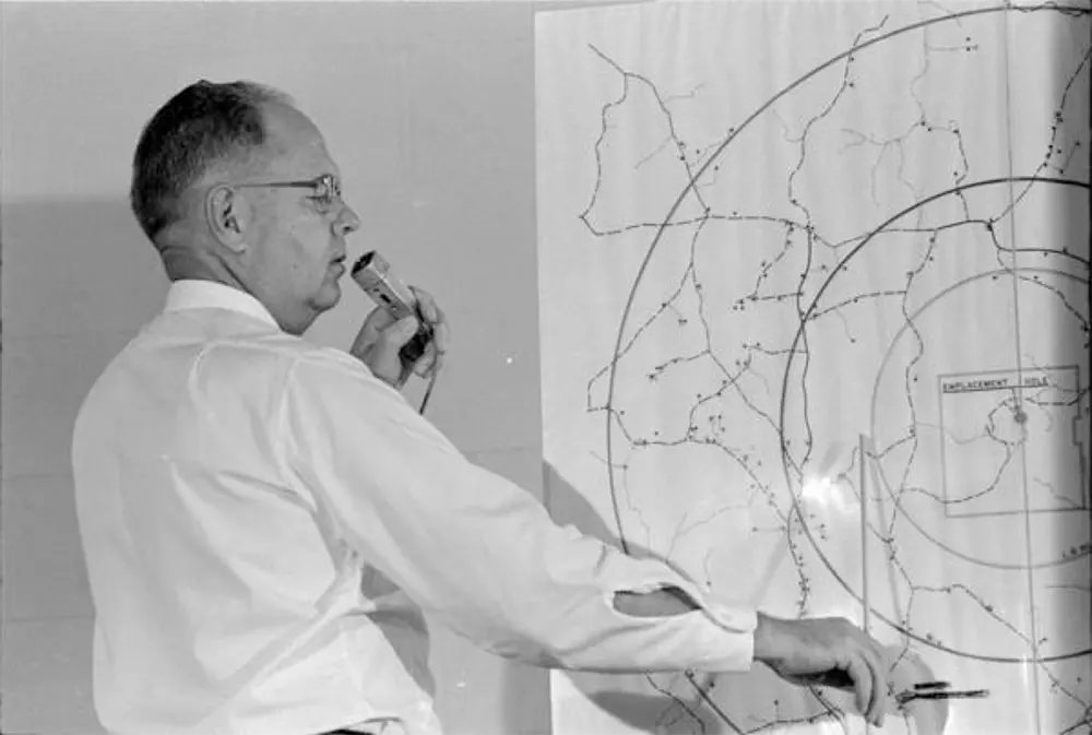 #4 Henry G. Vermillion, office of information director, U.S. Atomic Energy Commission, indicates evacuation area for the 1964 nuclear test site.