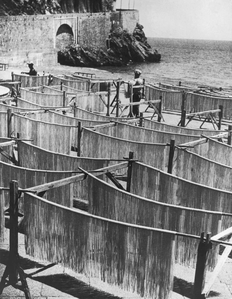 #41 Spaghetti drying on racks, known as ‘spaghetti horses’, on a beach near Amalfi, Italy, September 1949.