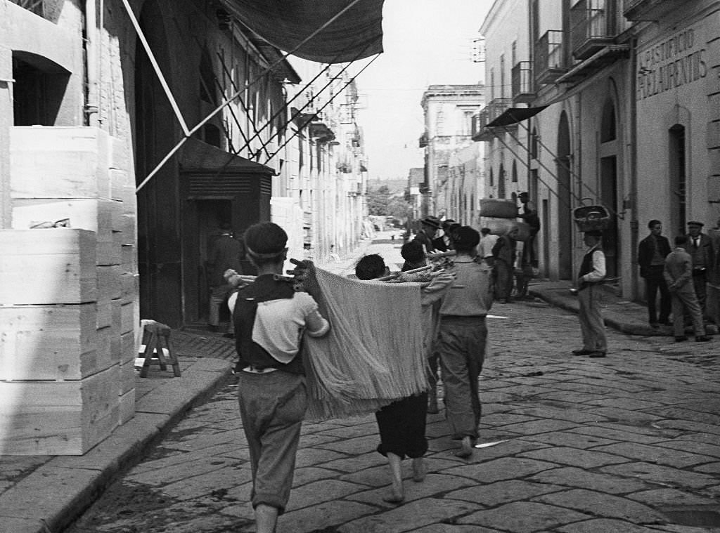 #52 Spaghetti production Carrying spaghetti through the small town of Torre Annunziata, the center of the local spaghetti production, 1932