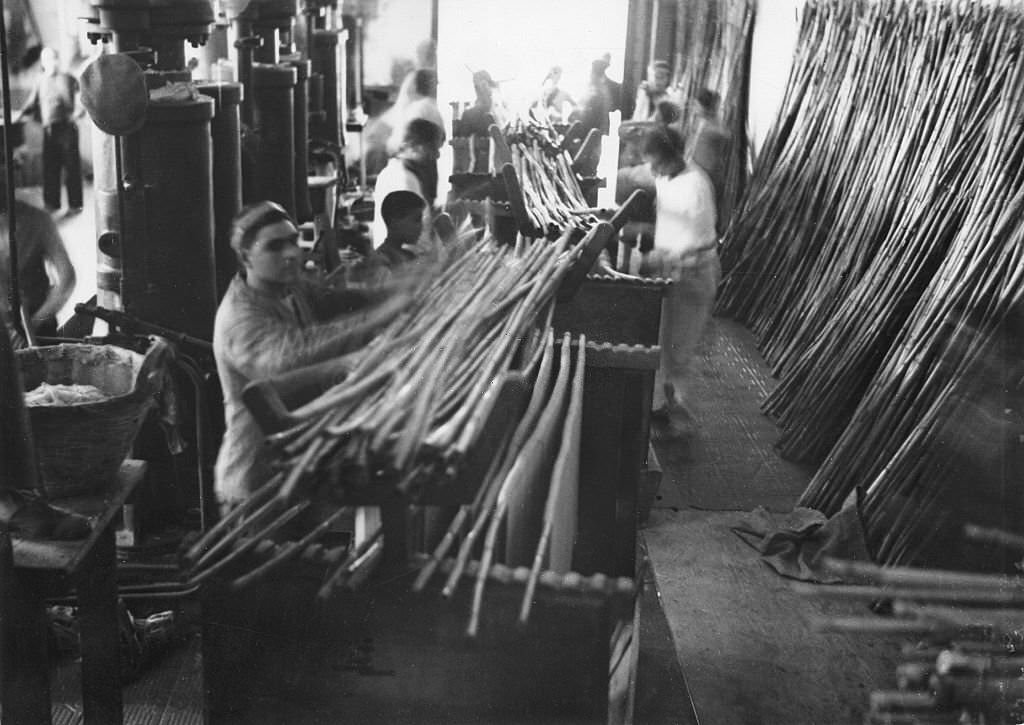 #54 Spaghetti production Workers hanging spaghetti over bamboo sticks to dry them, 1932