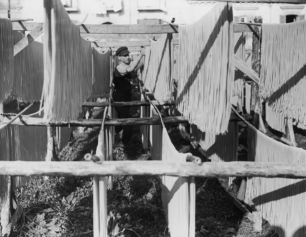#7 Strands of macaroni being hung out to dry, Naples, Italy, 1925.