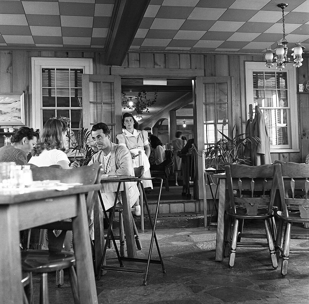 #6 A waitress at a restaurant leans upon the doorway as she spends a quiet moment on Cape Cod, Provincetown, Massachussetts, 1947.