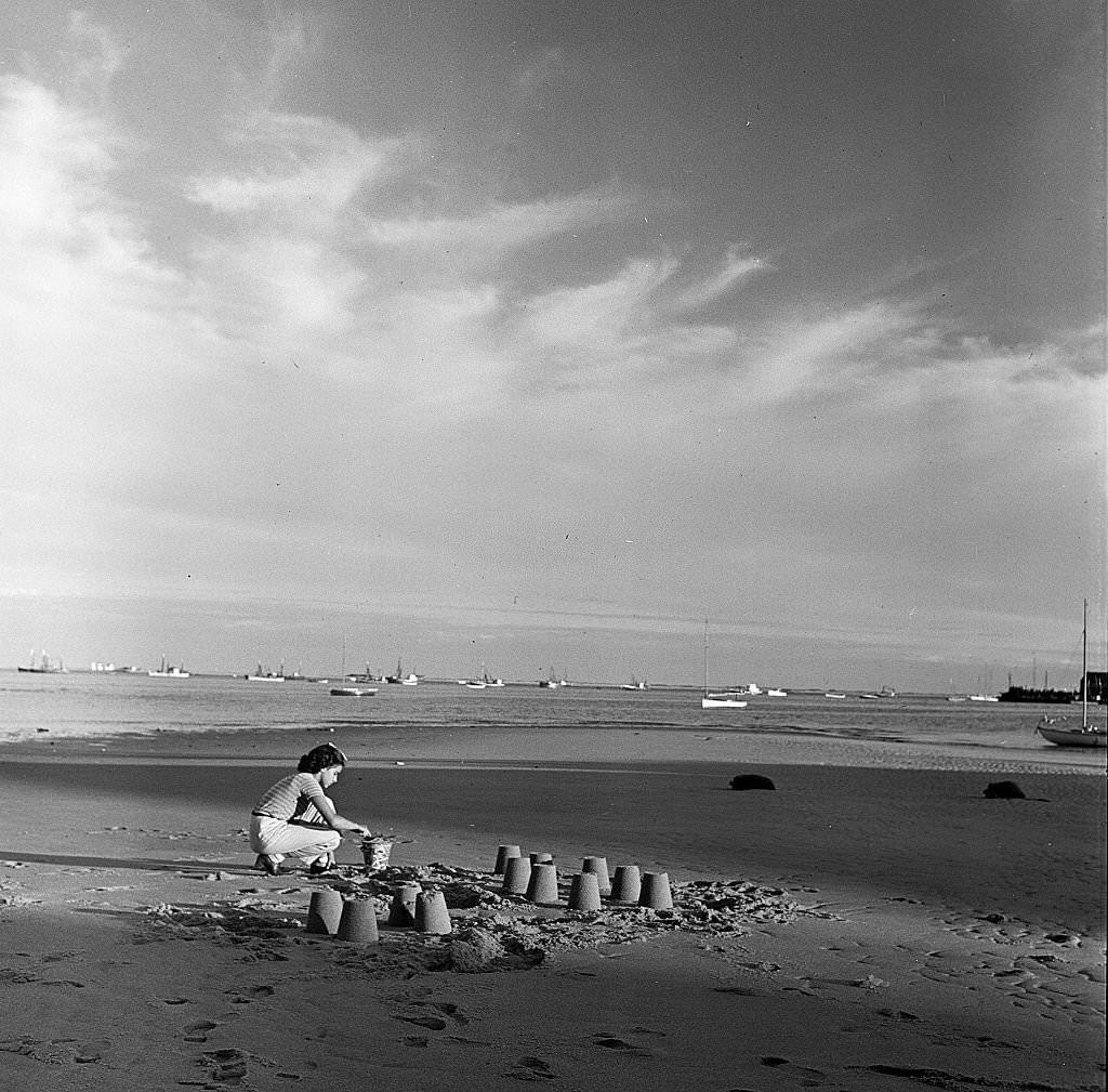 #103 A young girl builds sand castles on the beach, Provincetown, Massachusetts, 1948.