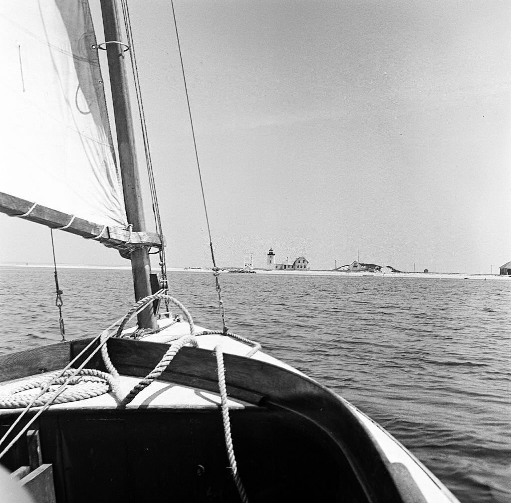 #18 A sailboat approaches a lighthouse on Cape Cod, Provincetown, Massachussetts, 1947.