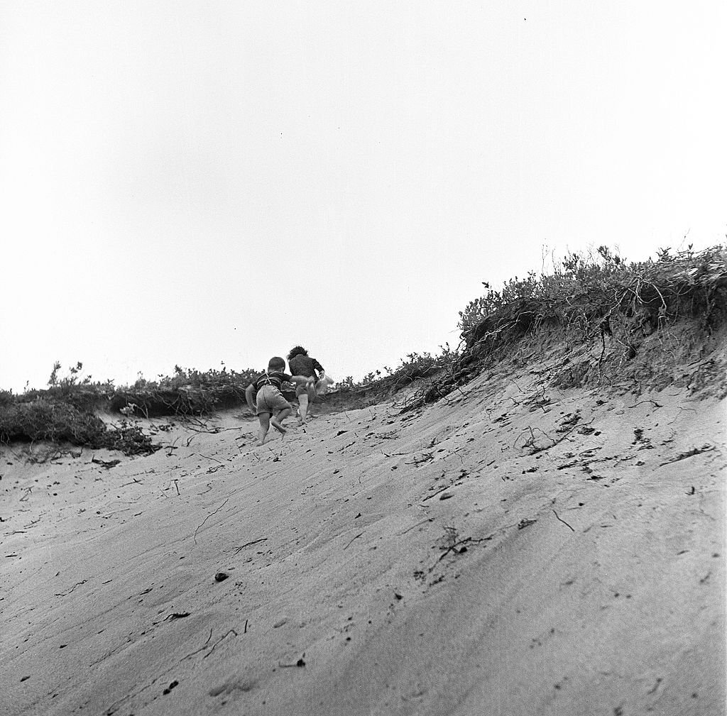 #151 Two young children, a boy and a girl, playin the sand dunes of the beach, Provincetown, Massachusetts, 1948.