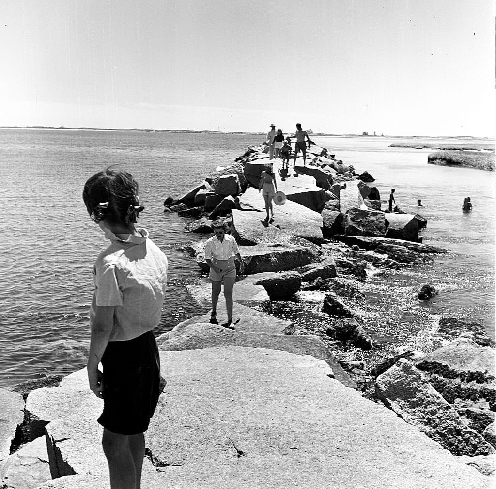 #154 Visitors walk along the breakwater, Provincetown, Massachusetts, 1948.