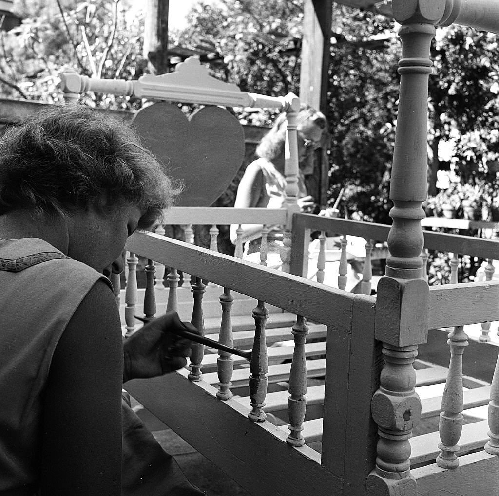 #52 An employee paints a crib for which will be for sale at an antique shop, Provincetown, Massachusetts, 1948.