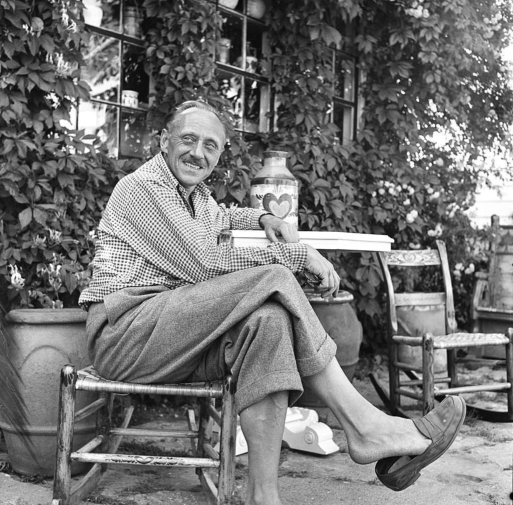 #56 A visitor relaxes outside on the grounds of an antique shop, Provincetown, Massachusetts, 1948.