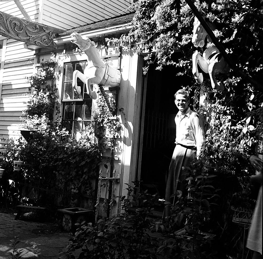 #57 A visitor stands at the entrance to an antique shop, Provincetown, Massachusetts, 1948.