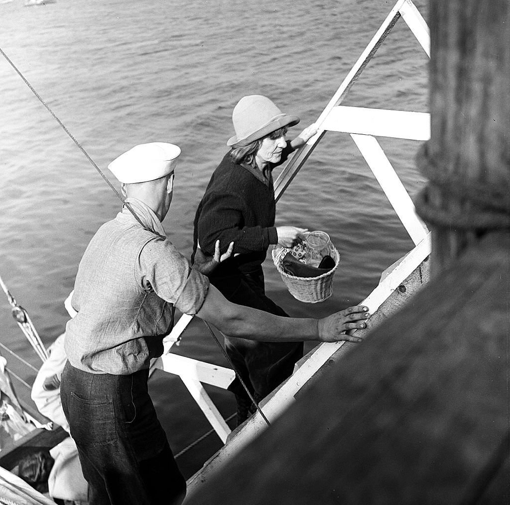 #64 Visitors disembark from a boat at the pier, Provincetown, Massachusetts, 1948.