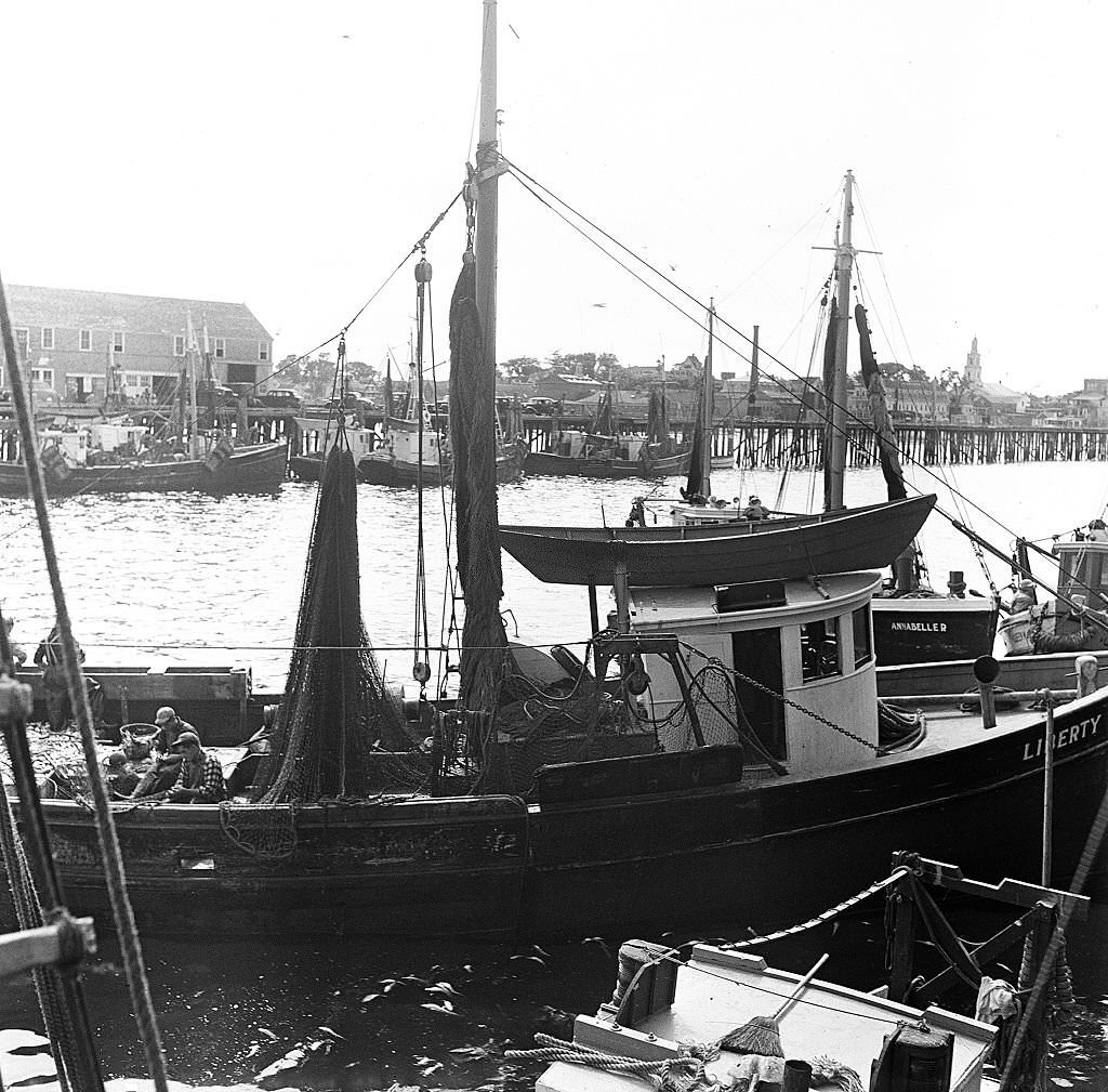 #76 Fishing boats docked on a pier on Cape Cod, Provincetown, Massachussetts, 1947.