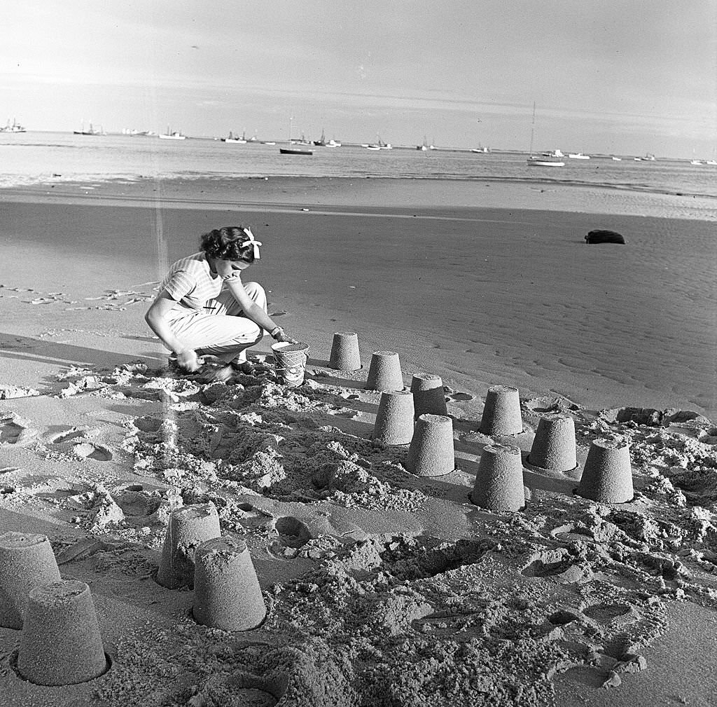 #93 A young girl builds sand castles on the beach, Provincetown, Massachusetts, 1948.