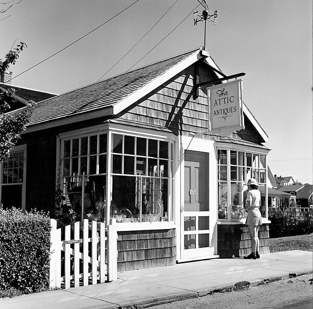 #98 View of a woman looking into the window of the Attic Antiques shop, Provincetown, Massachusetts, 1948.