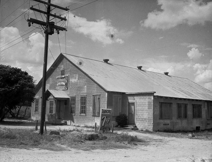 #112 Exterior of Converse Hall, 1941. The exterior of Converse Hall with Royal Crown cola sign and 7-Up sign.