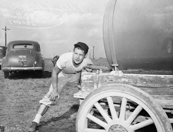 #138 Eddie Kazak drinks from water wagon during baseball practice, 1943