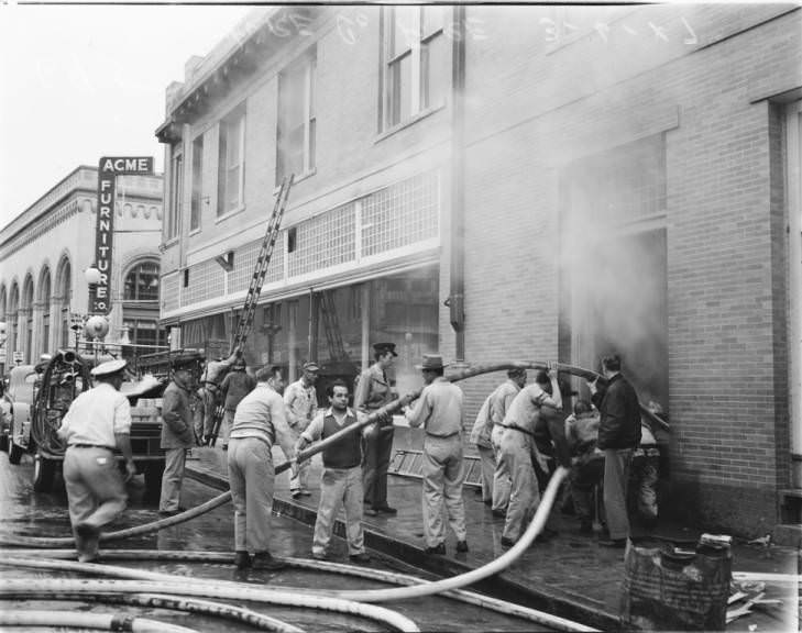 #35 A firemen trying to extinguish a fire at the Acme Furniture Company on East Commerce, 1947