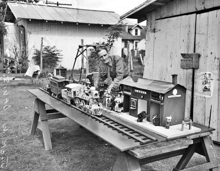 #47 Jack W. Davis and model wooden train and station, 1947
