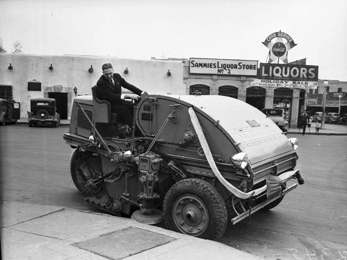 #190 Henry Hein operating new mechanical street sweeper, 1940