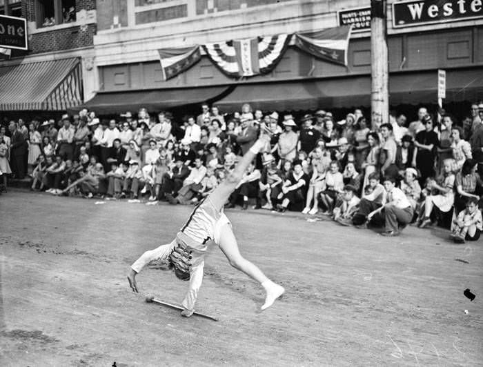 #192 1940 Battle of Flowers Parade – Drum major turning cartwheel, 1940