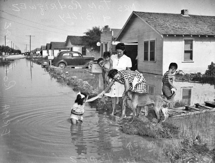 #91 Family on flooded Flanders Street, 1946
