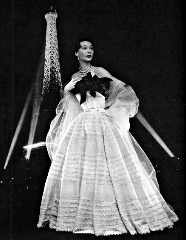 #34 Sophie Malgat in white organdy gown adorned with red roses by Jacques Fath, 1951