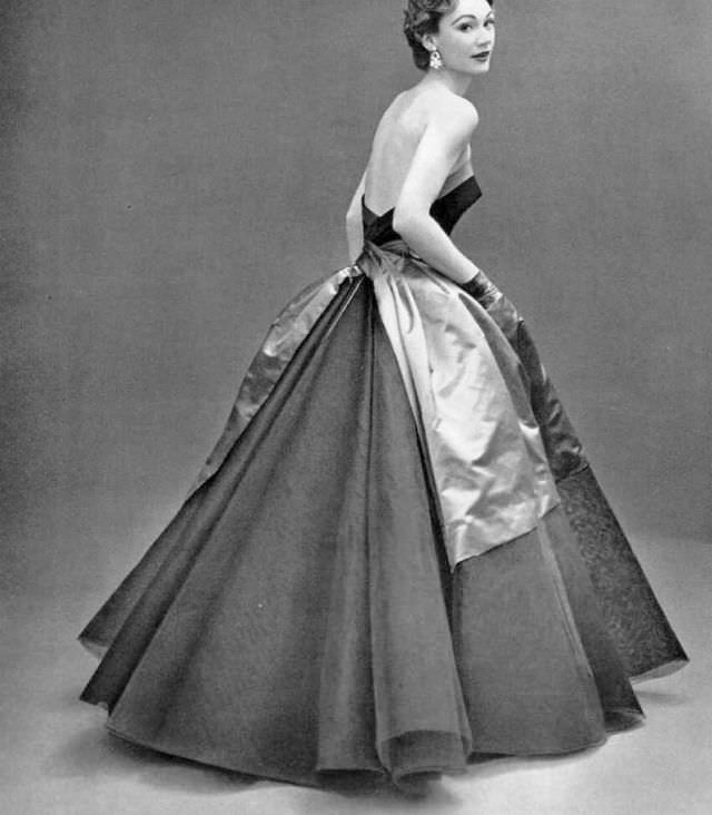 #13 Sophie Malgat in black tulle and lace ball gown adorned with blue satin sash, by Elsa Schiaparelli, 1952