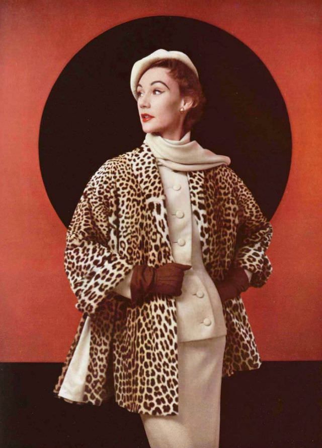 #2 Sophie Malgat in egg-shell flannel suit with collar scarf, worn with collarless panther fur jacket that has slits on the side by Christian Dior, 1952