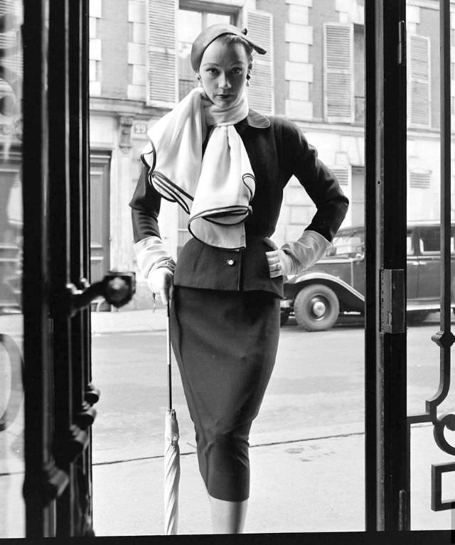 #8 Sophie Malgat in Givenchy’s slim suit worn with wide scarf, February 1952