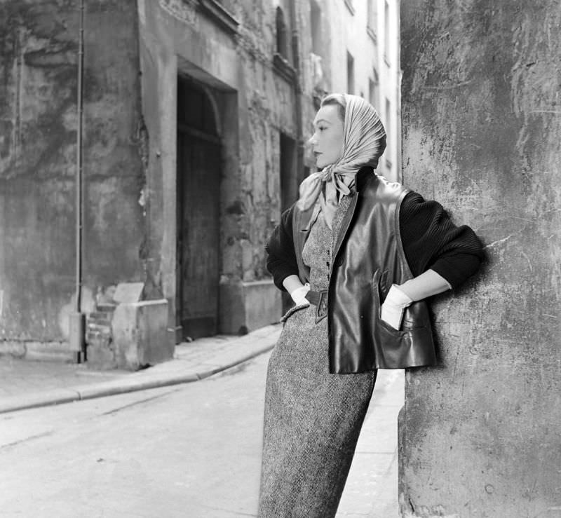 #11 Sophie Malgat is wearing slim tweed dress under leather jacket with knit sleeves by Givenchy, Paris, February 1952