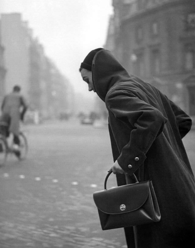 #12 Sophie Litvak wearing coat and handbag by Jacques Fath, Elle, January 12, 1953