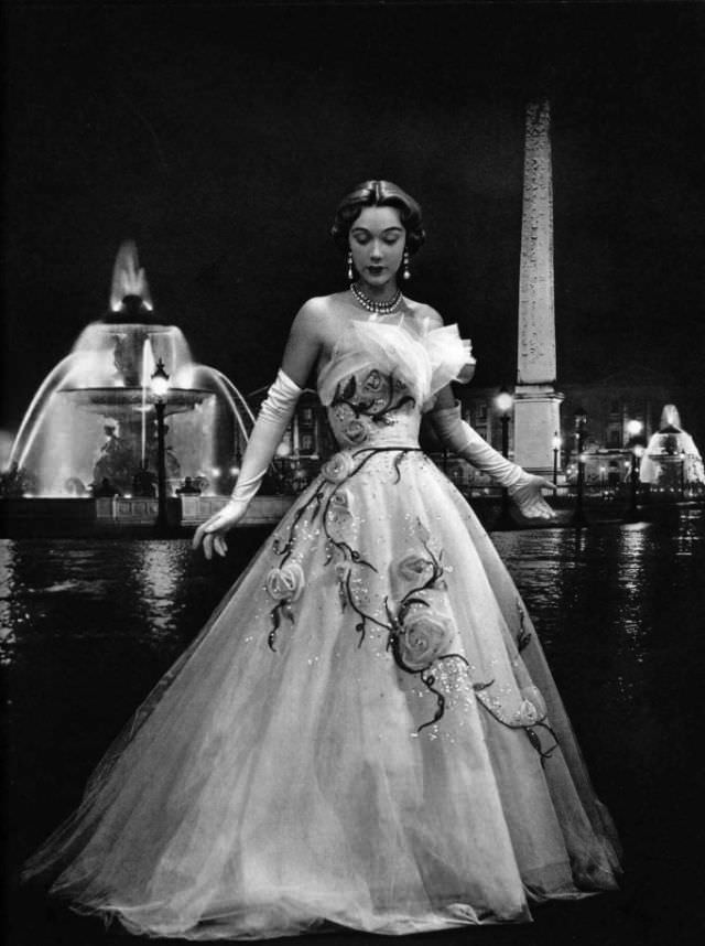 #27 Sophie Malgat in an enchanting evening gown of white tulle adorned with pale pink roses and scattered with rhinestones by Jeanne Lafaurie, 1951