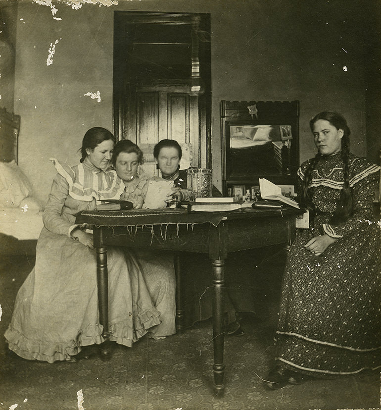 #11 Three students study in their dorm room, most likely in Georgia Burleson Hall, 1890s