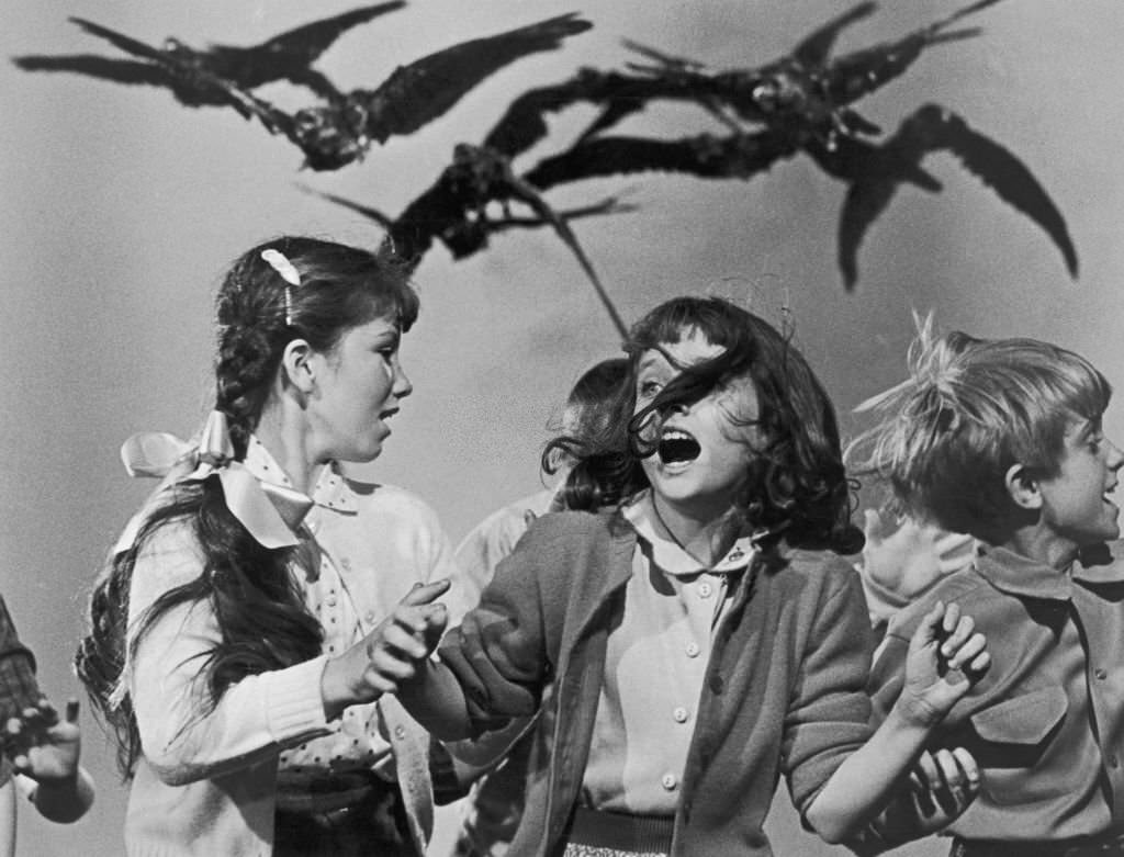 A group of schoolchildren flail about in terror at the avian attack in a publicity still for ‘The Birds’, 1963