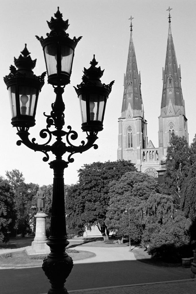 #12 Strolling through Universitetsparken, with a view on St. Erik’s Cathedral and a statue honoring writer and composer Erik Gustaf Geijer, 1969.