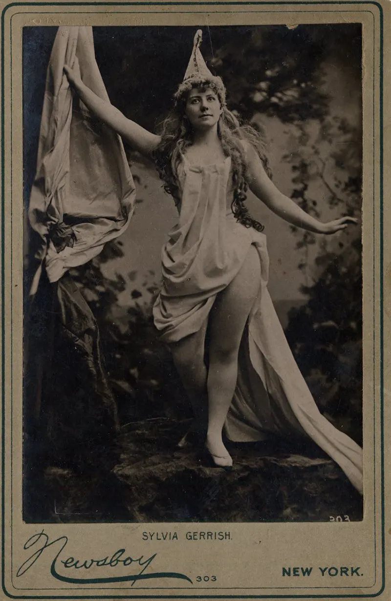#9 Sylvia Gerrish with draped dress and pointed hat in the woods.