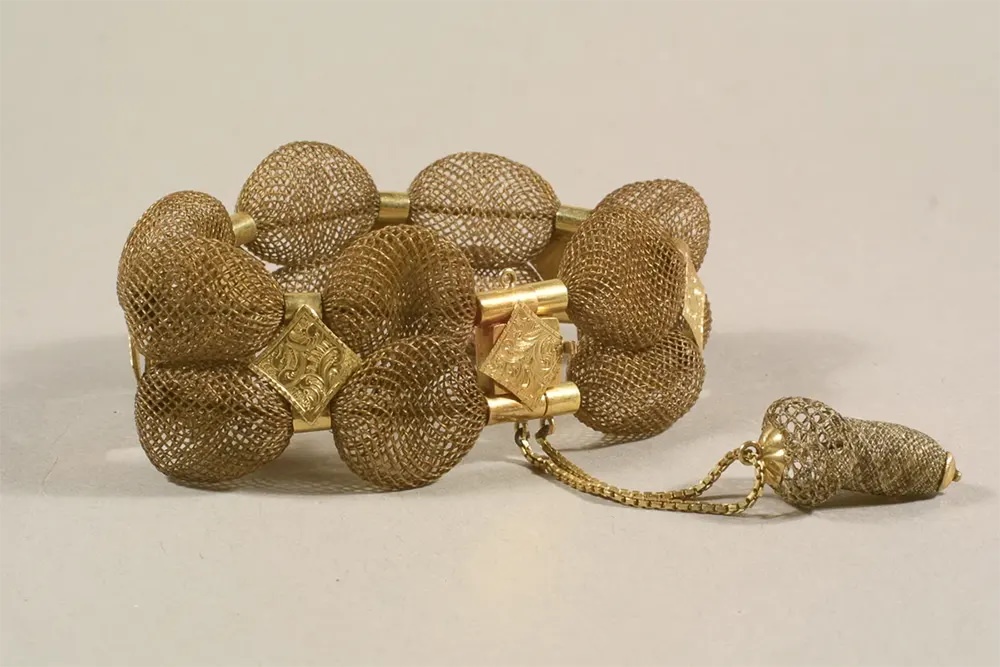 #12 A bracelet made of brown table-worked hair with gold diamond findings.