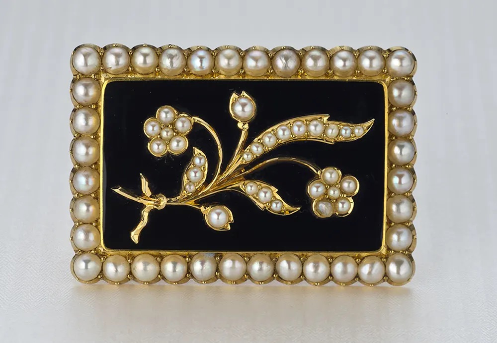 #18 A pearl and black chalcedony Victorian mourning pin with a floral motif reflects a gentler view of death.