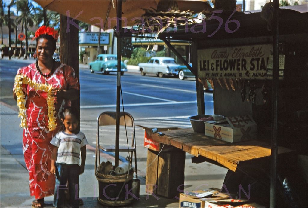 #73 A bit shaky but still interesting snap of Kalakaua Avenue seen from a truck lei stand on the street front of the Royal Hawaiian Hotel looking towards the old Waikiki Theater, 1956