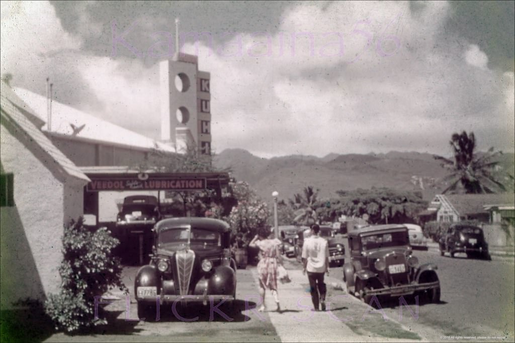 #16 Looking mauka along Kalaimoku Street in Waikiki. You could get your car lubed while taking in a movie, 1946